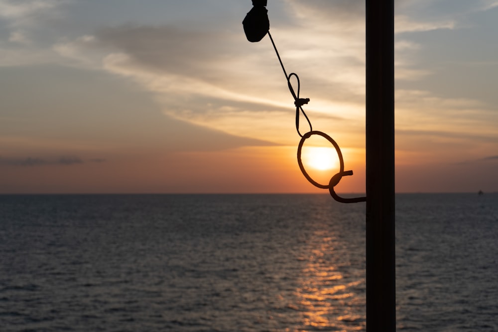 a light post with a sunset in the background