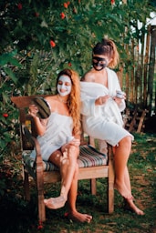 two women sitting on a chair