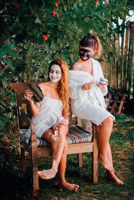 two women sitting on a chair