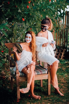 two women sitting on a chair