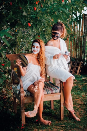 two women sitting on a chair