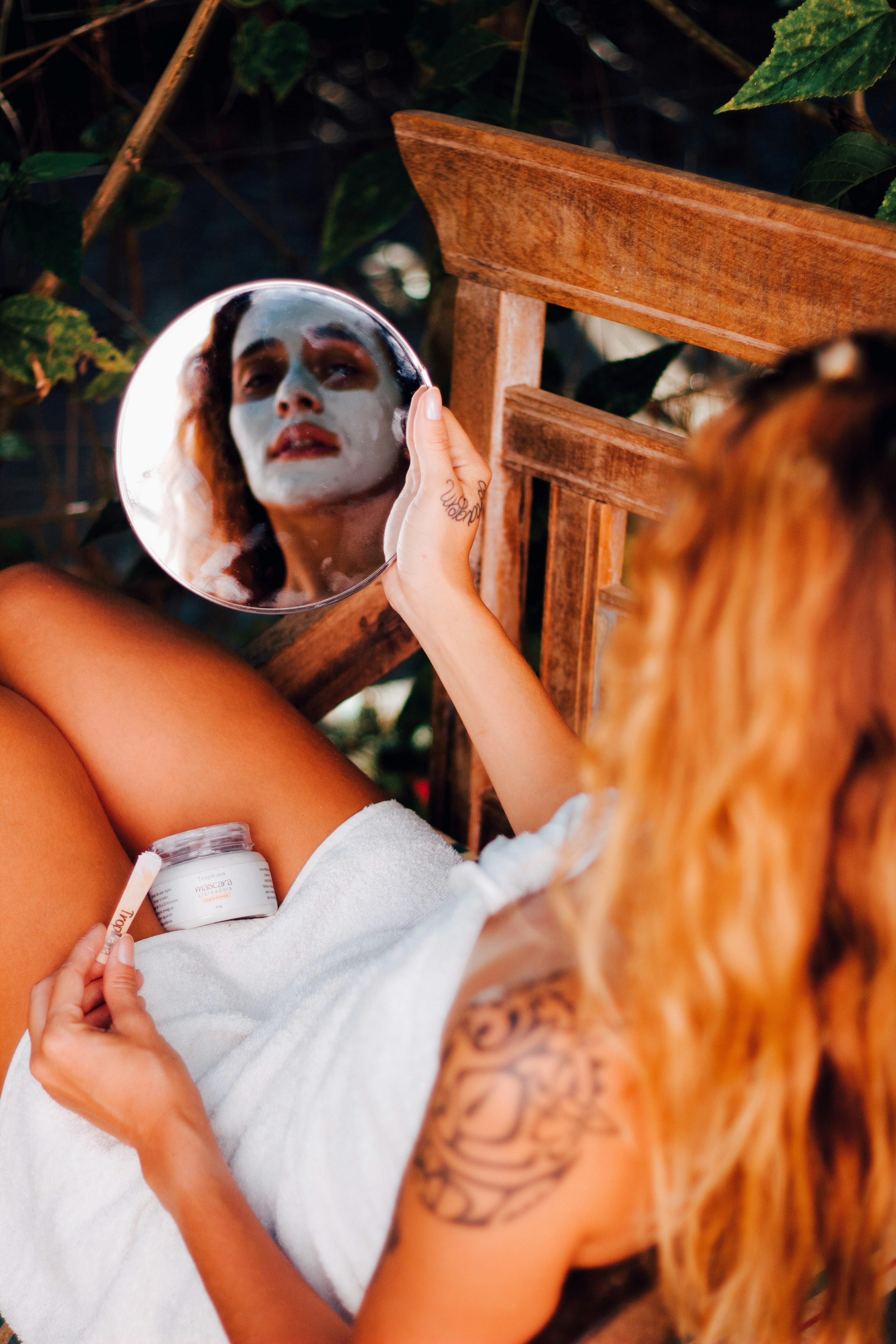 a woman in a white dress holds a cell phone