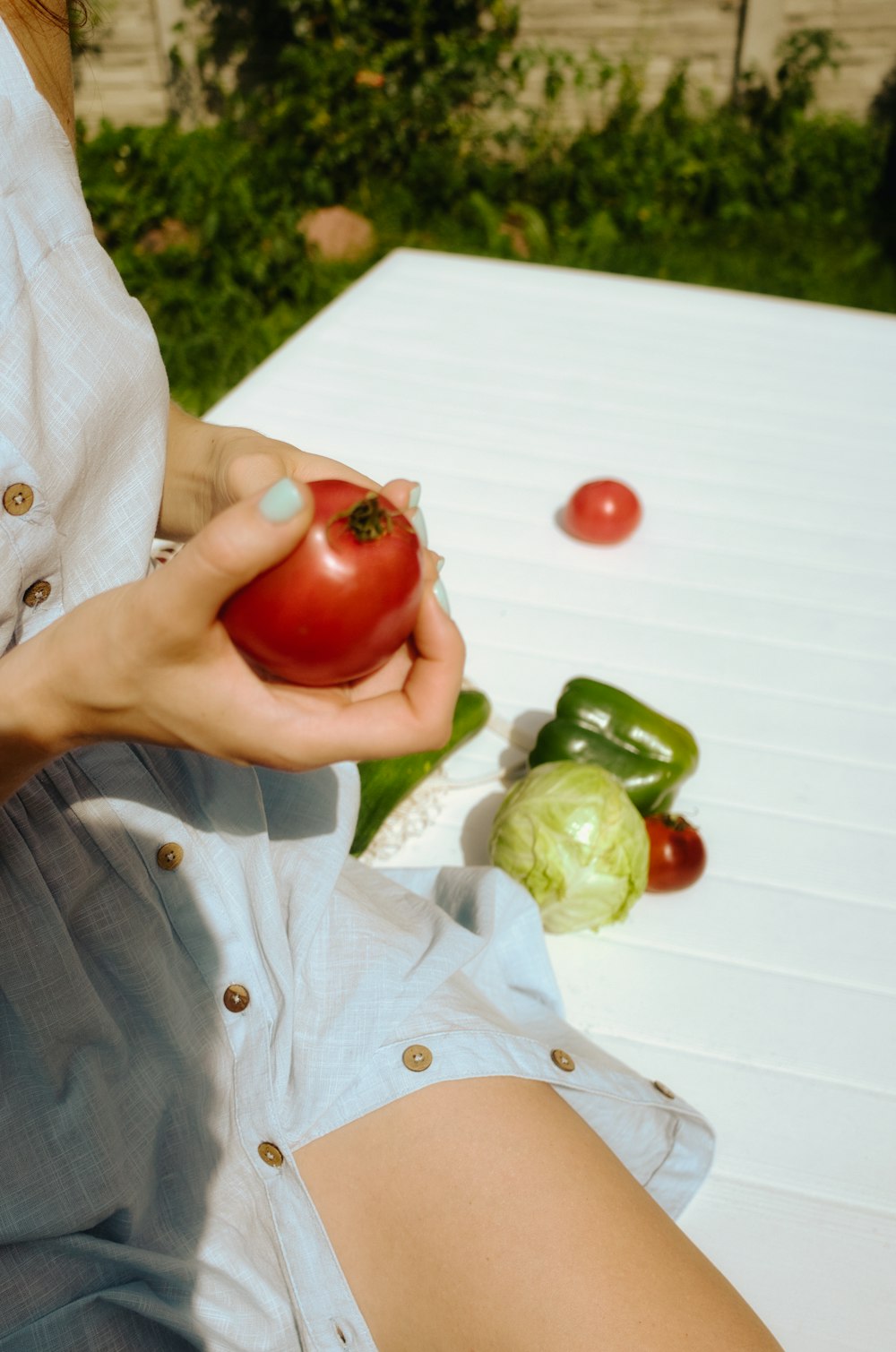 a person holding a tomato