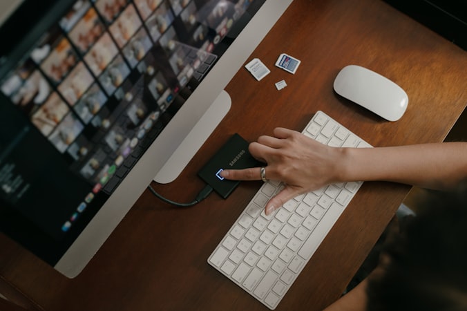 A person typing on a keyboard at a desk