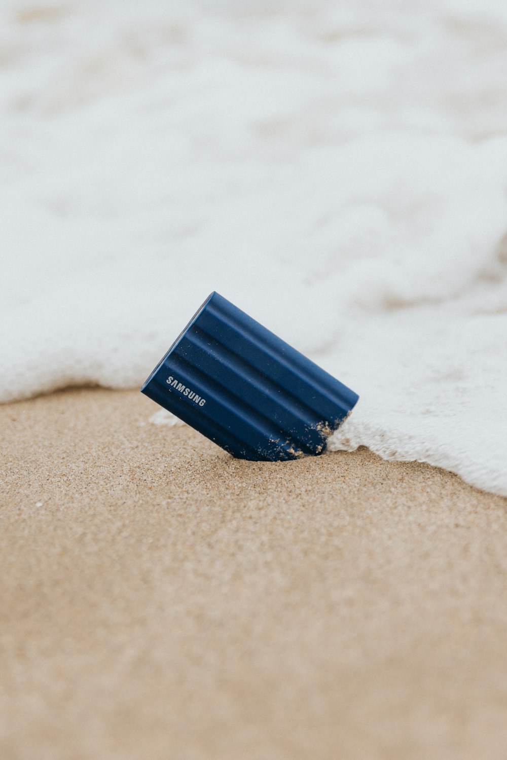 a blue pen on a white surface