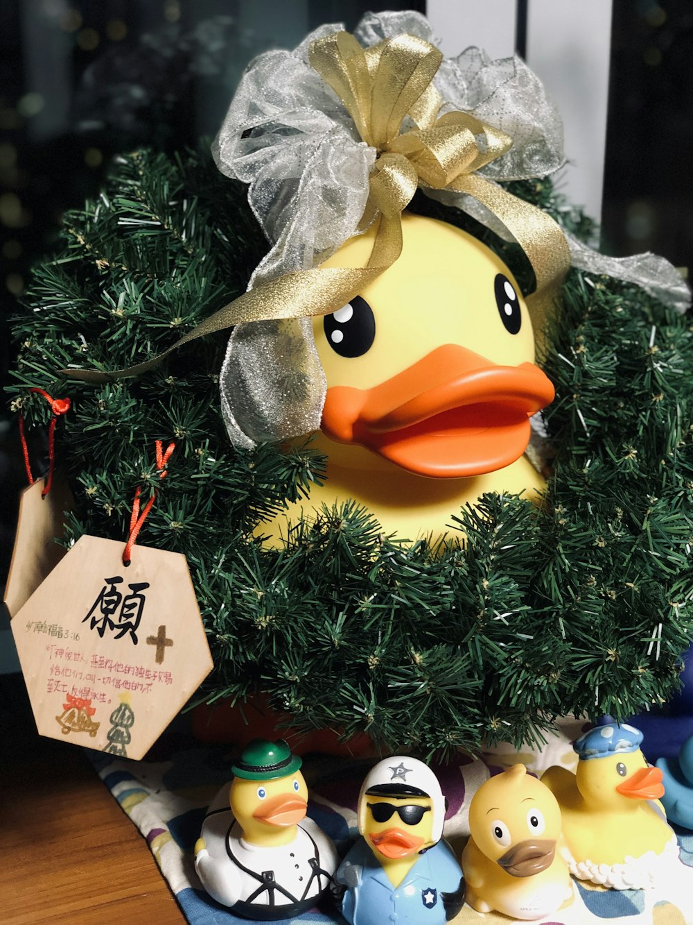 a tree with a sign and a group of rubber ducks