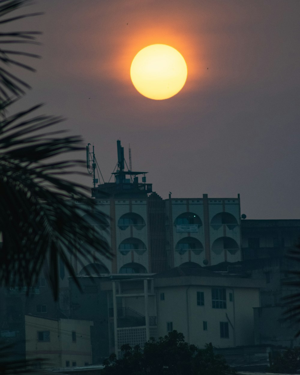 a building with a large orange sunset