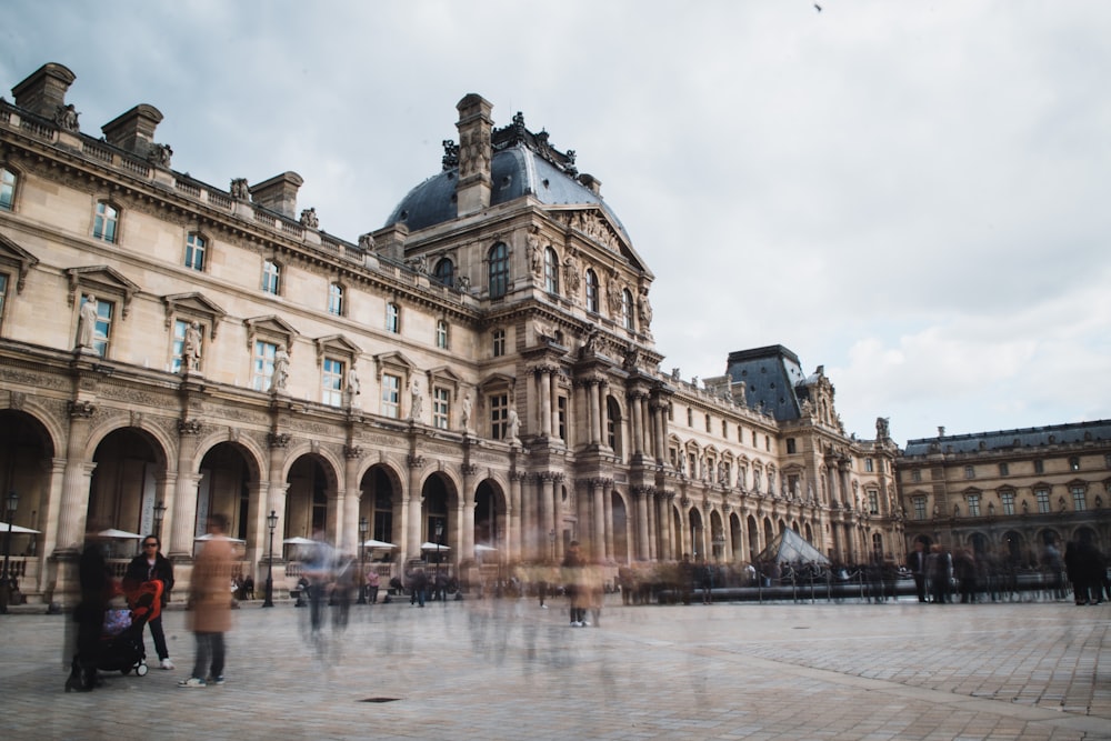 a large building with a courtyard with Louvre in the background