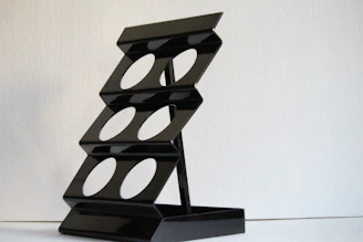 Minimalist 3D printed key holder in matte black against a white background.