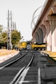 a yellow truck on the tracks