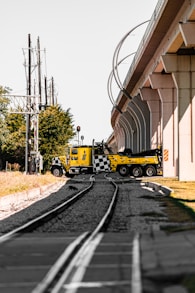 a yellow truck on the tracks