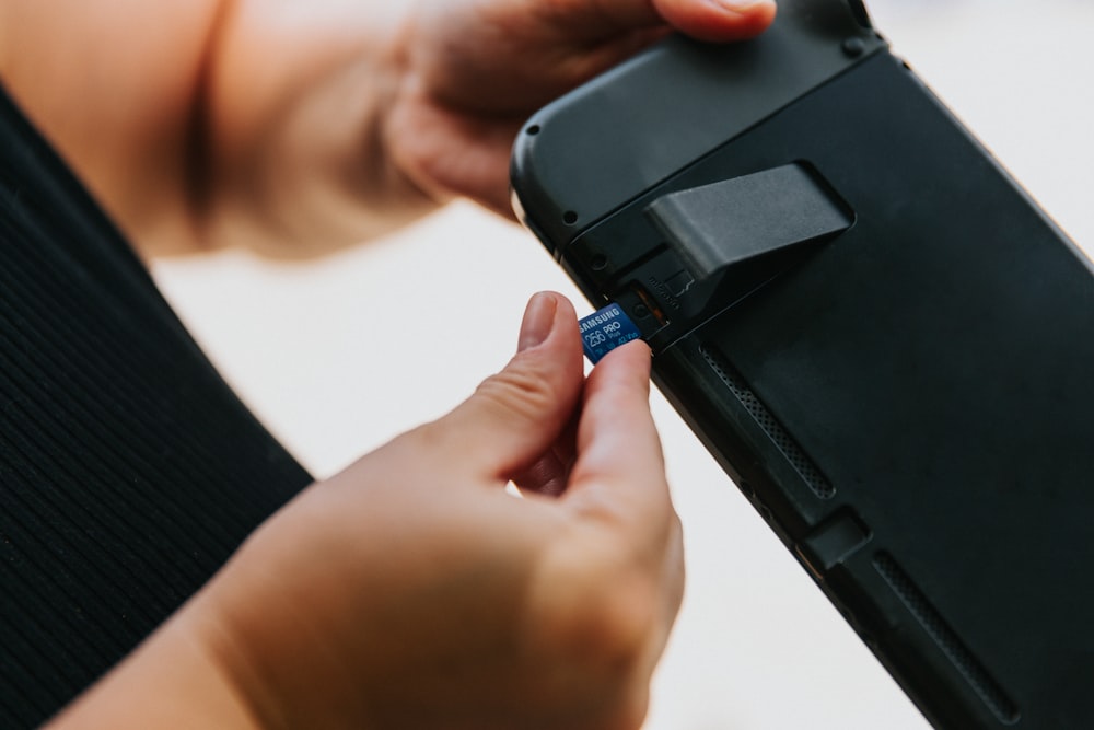 a person holding a black device