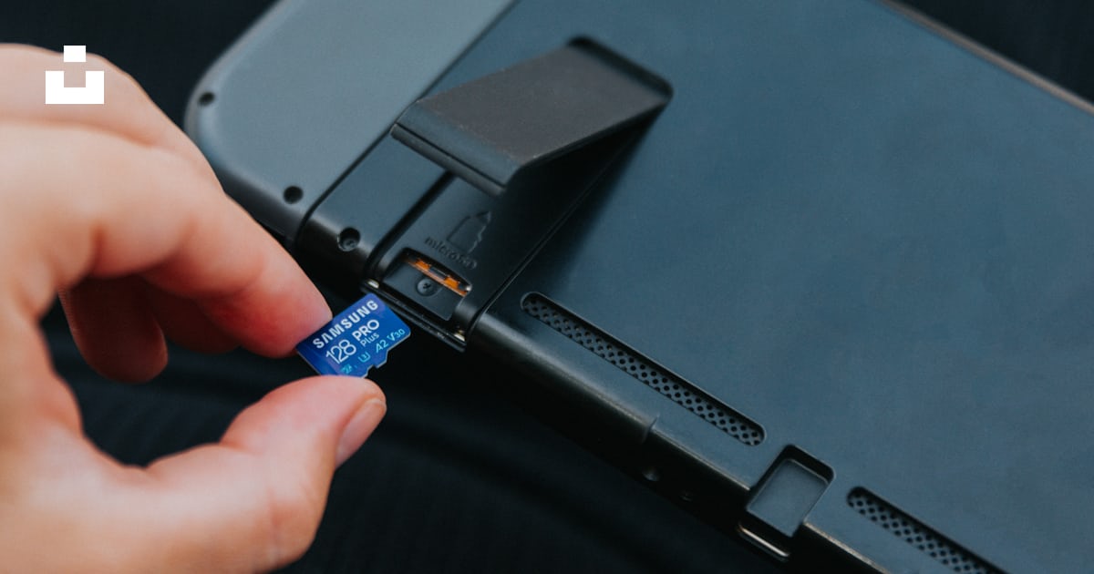 A hand holding a black rectangular device photo – Free Nintendo Image ...