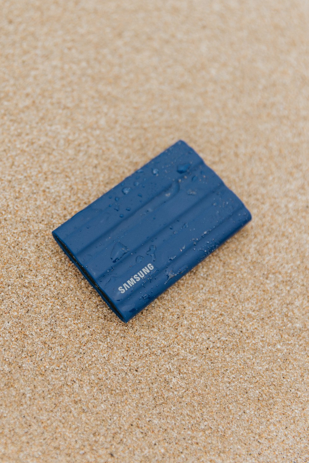 a blue rectangular object on a tan surface