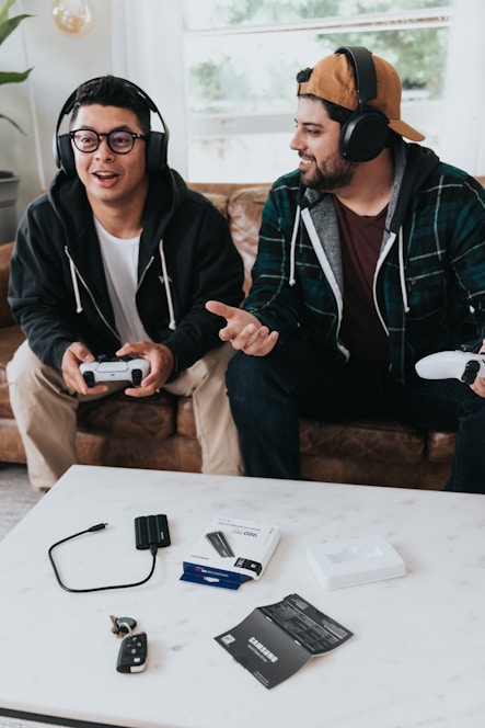 a couple of men wearing headphones and sitting at a table