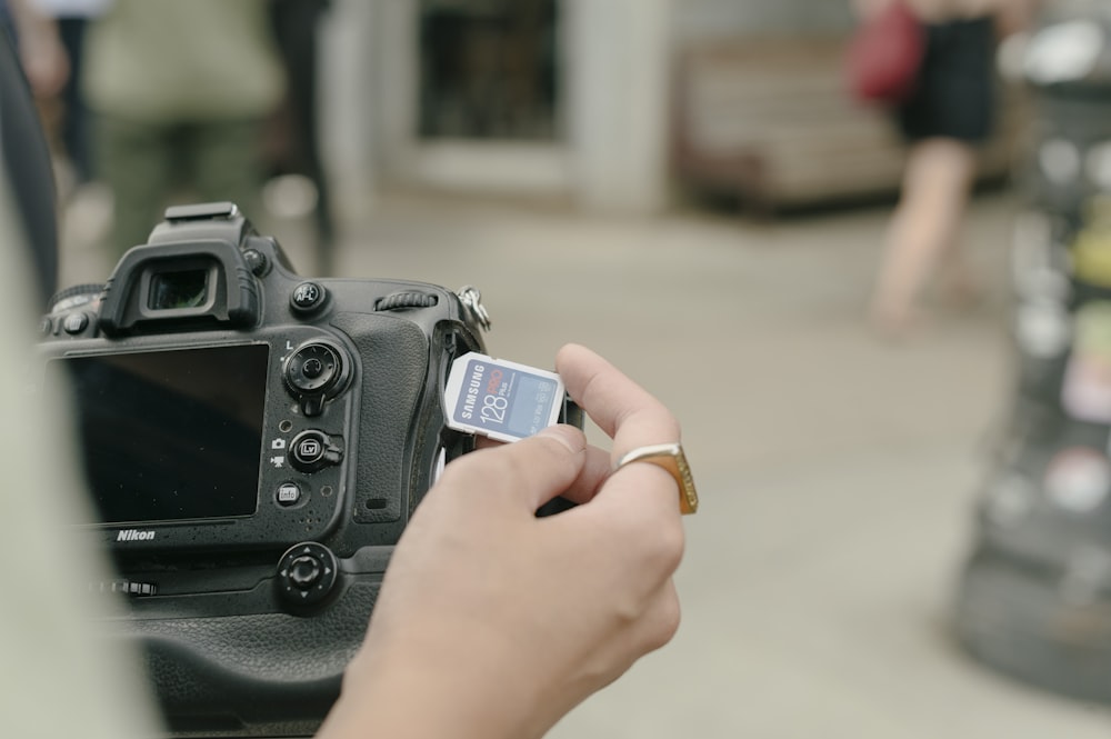 a hand holding a camera