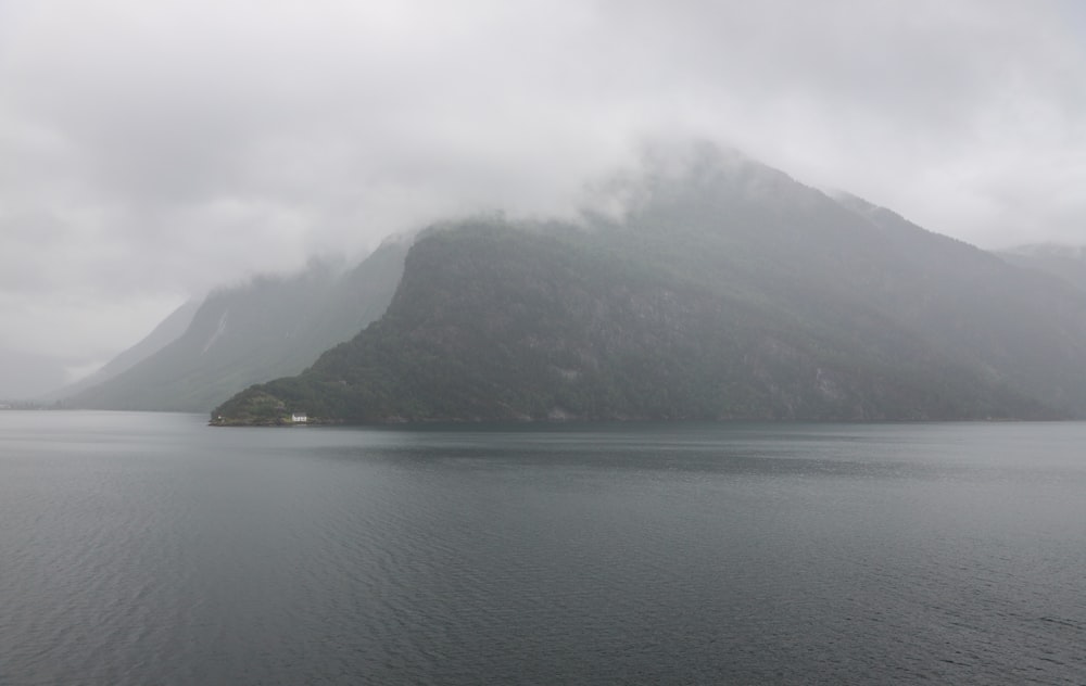 a body of water with hills in the background