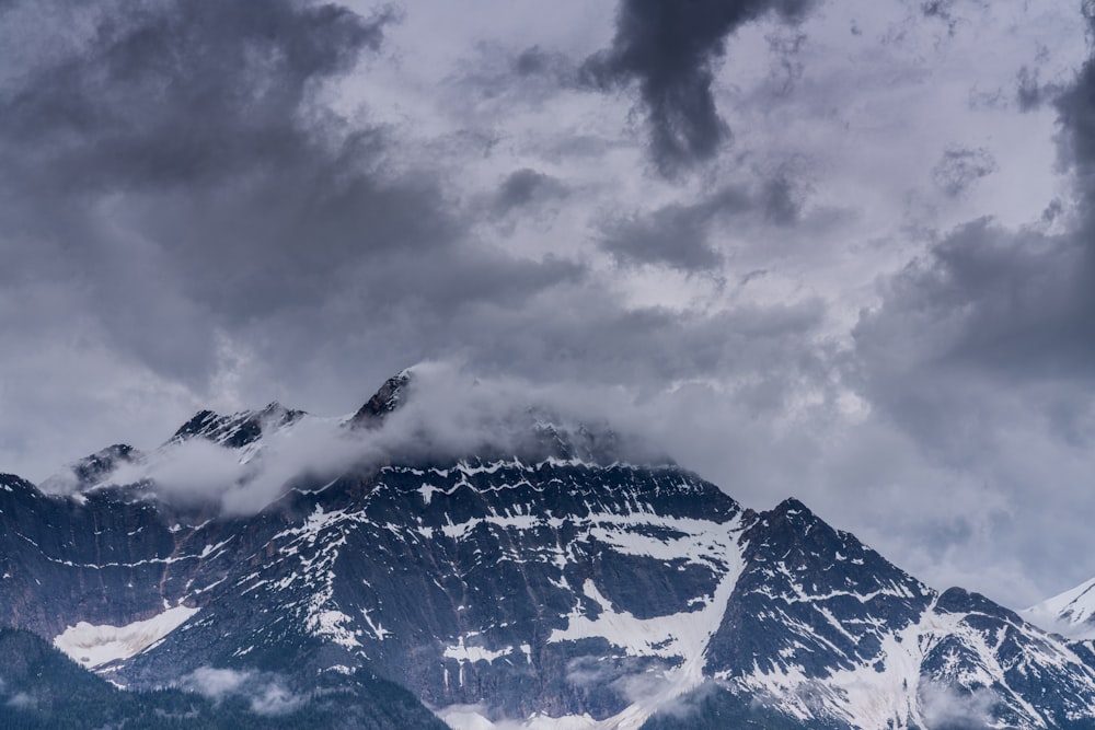 a mountain with clouds above it