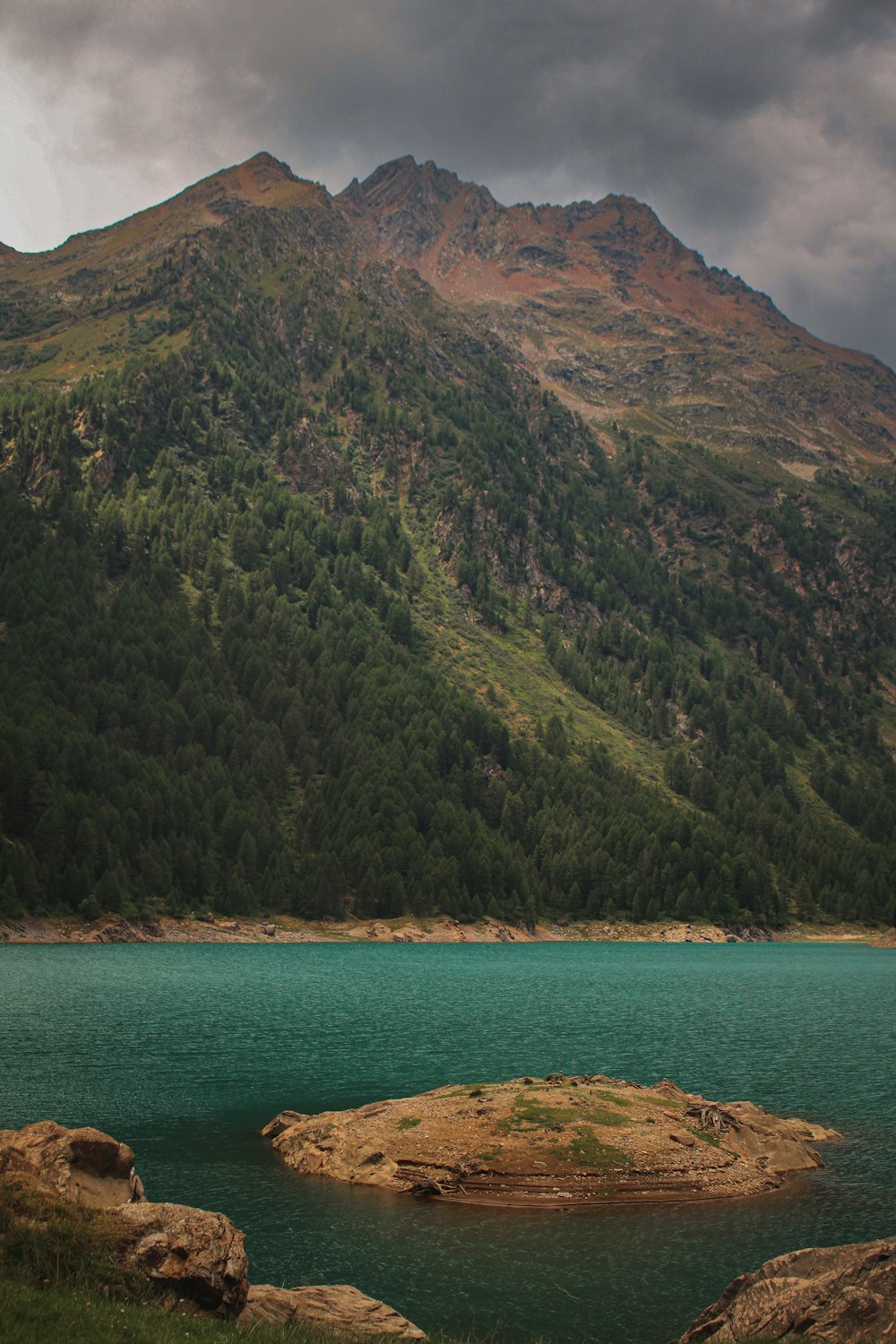 a body of water with a mountain in the background