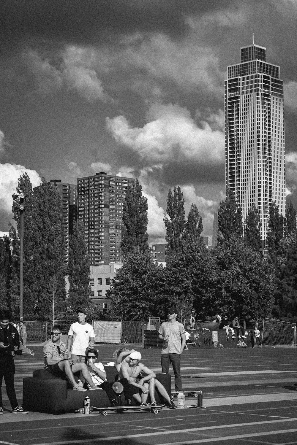 a group of people sitting on a bench in front of a tall building