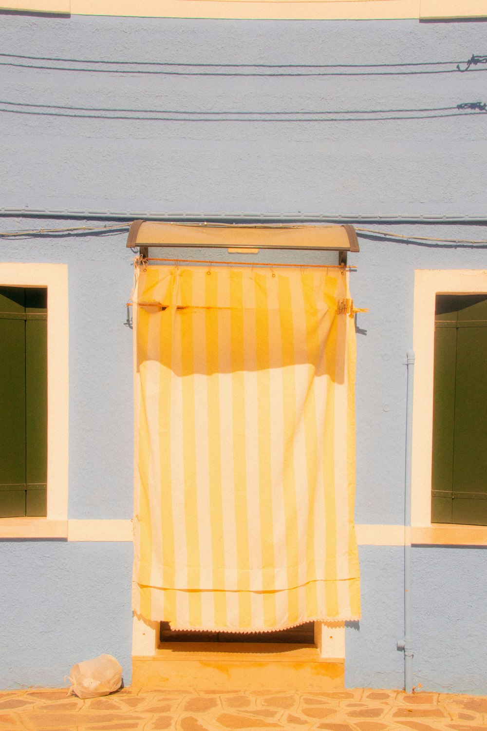 a yellow and white striped curtain