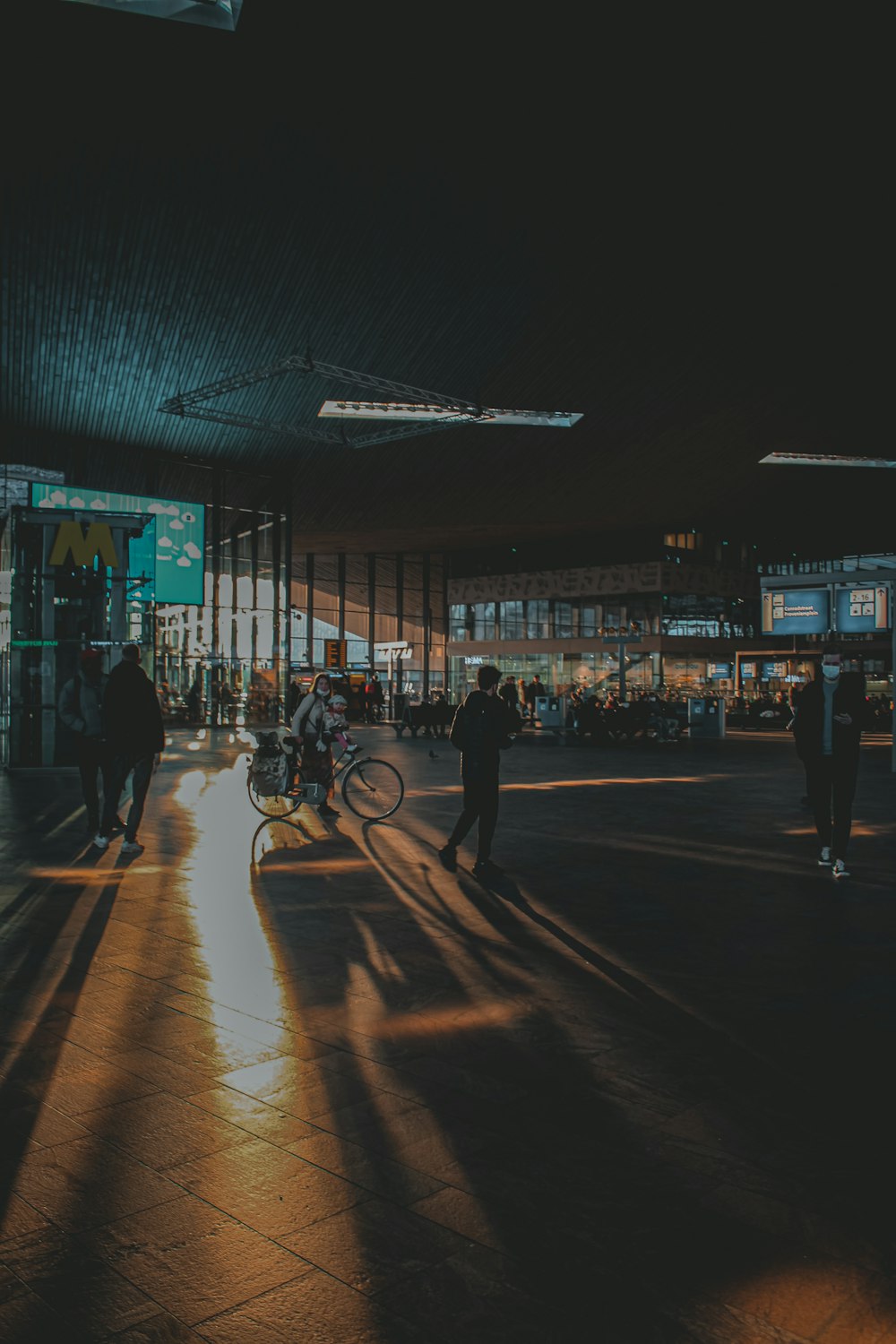 a group of people walking on a street at night