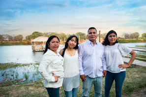 Friendly group photo of the four team members standing together outdoors.
