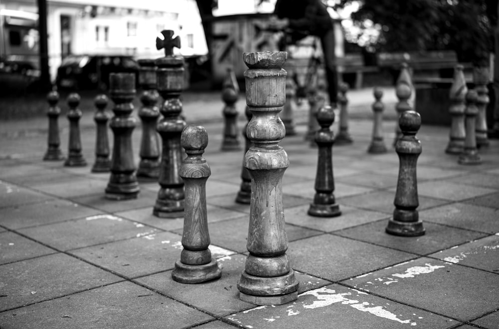a row of chess pieces on a sidewalk