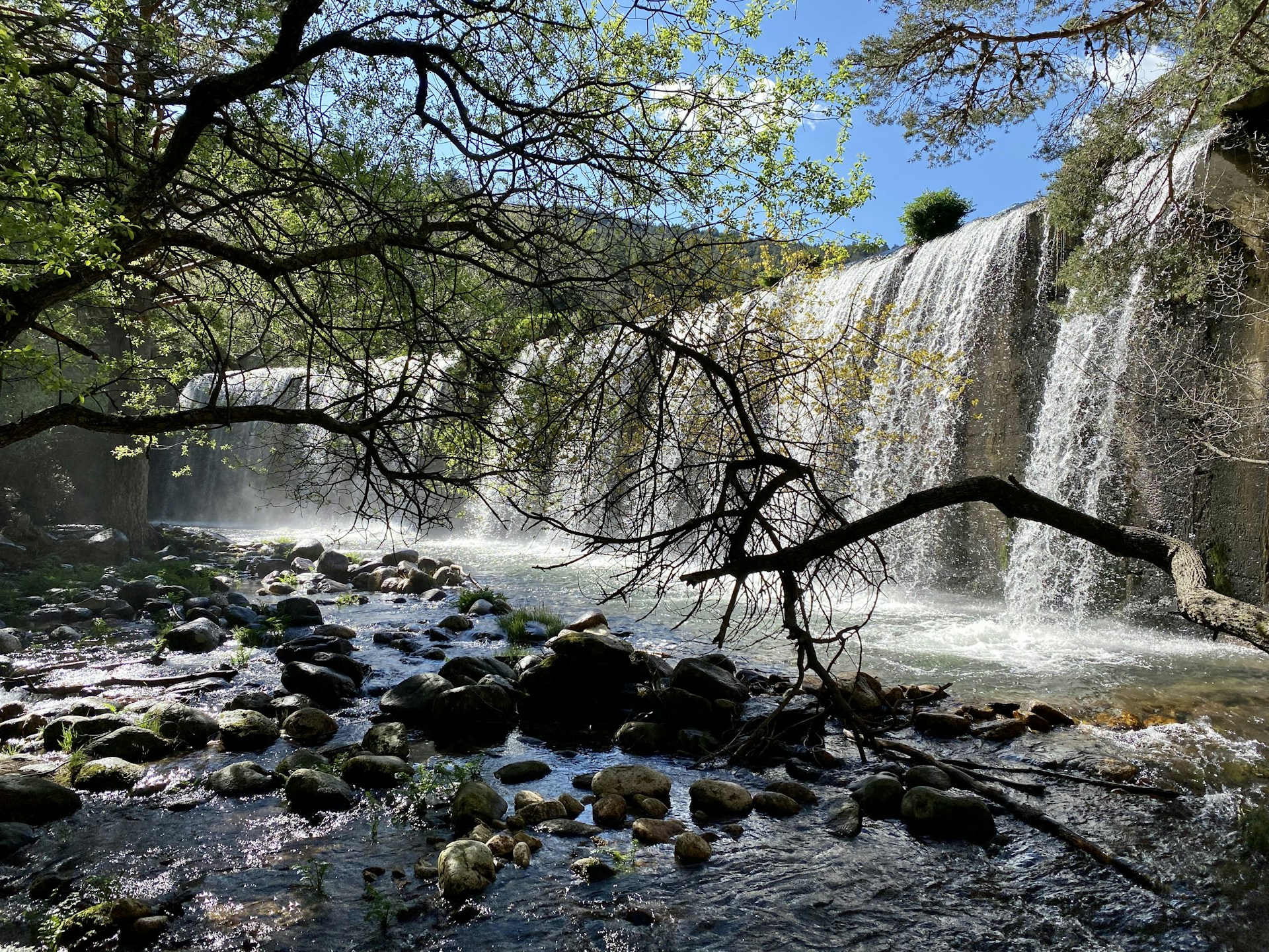 a waterfall over a rocky river