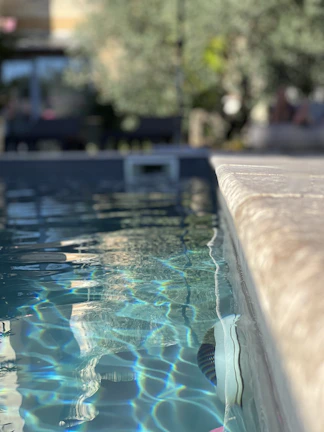 Close-up of sparkling clear pool water reflecting sunlight