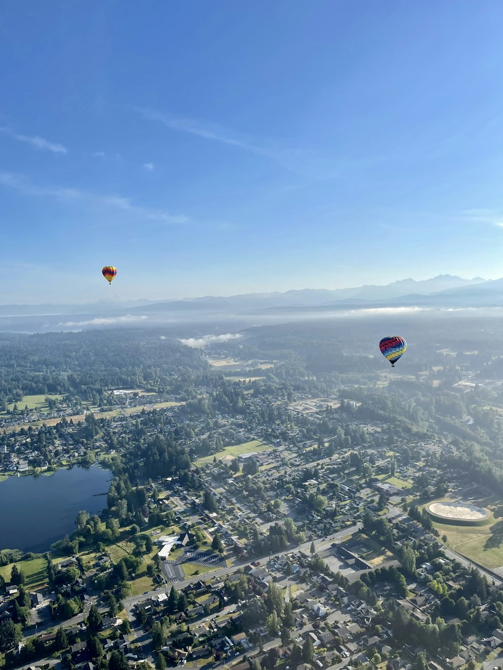 a group of hot air balloons flying over a city