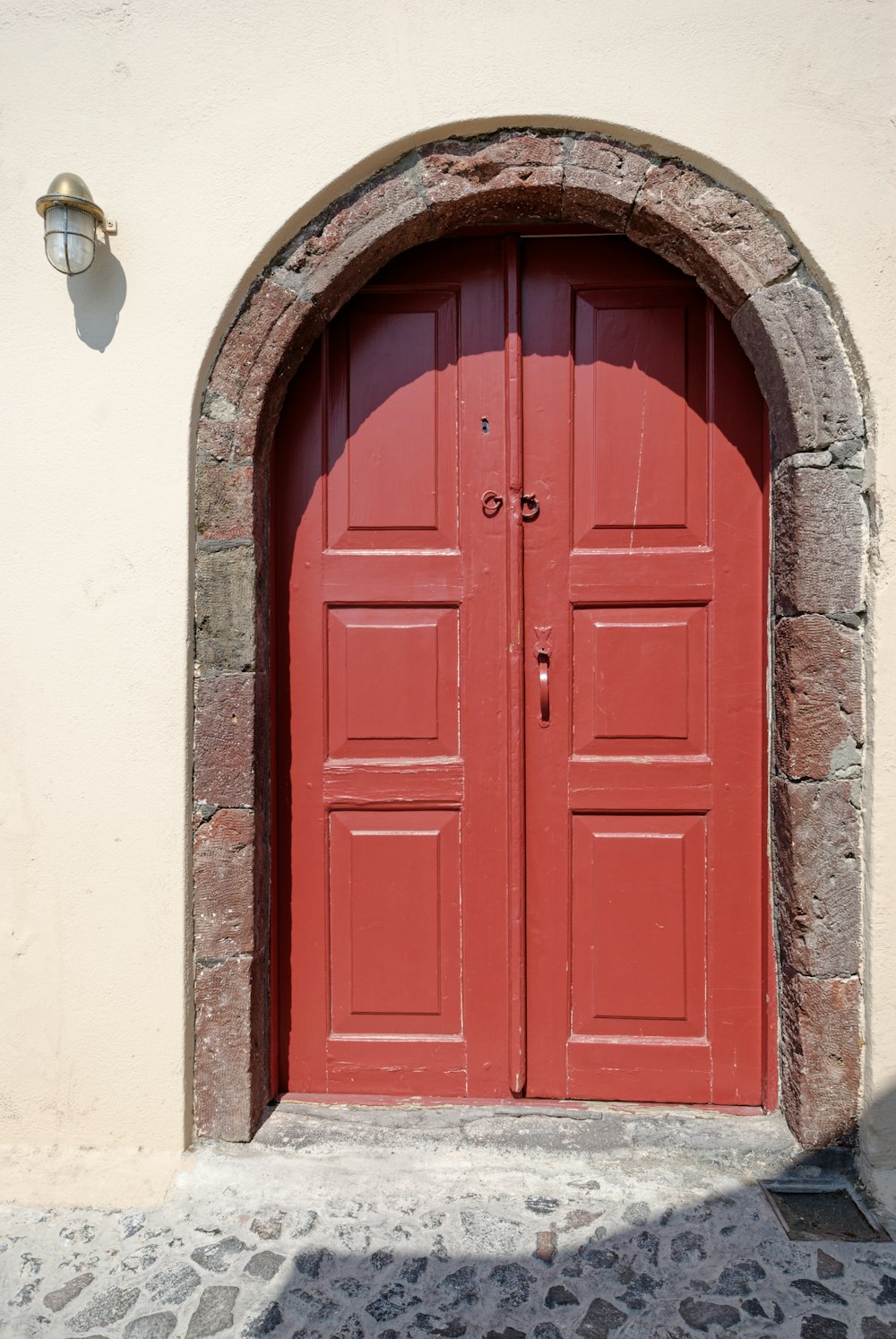 a red door in a stone building