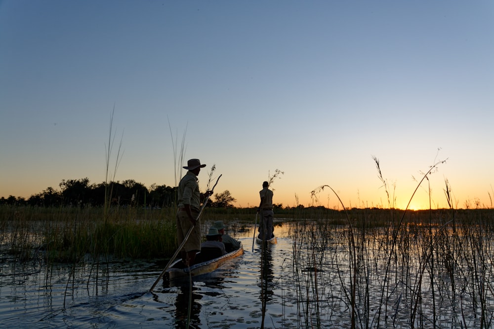 a group of people fishing in a river