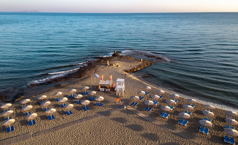 a beach with many chairs and umbrellas