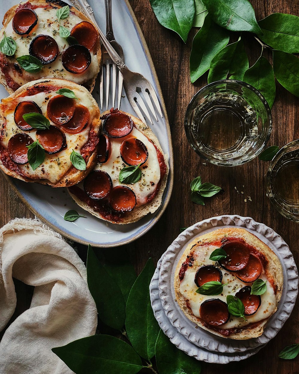 a table with plates of pizza