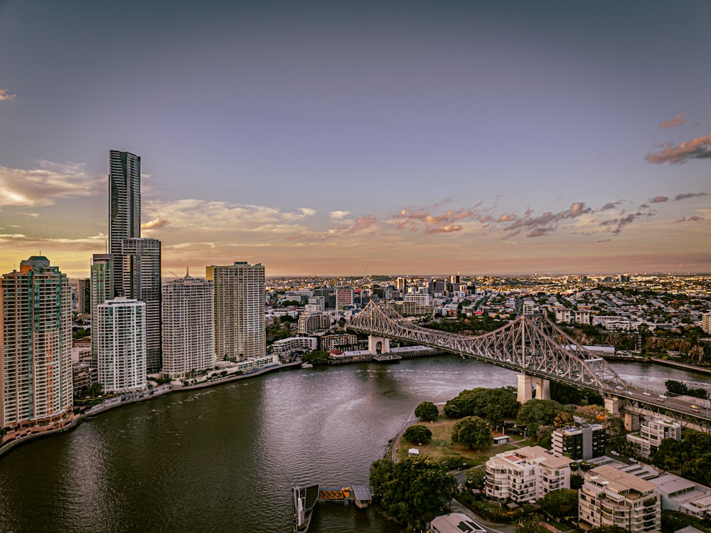 a bridge over a river with a city in the background