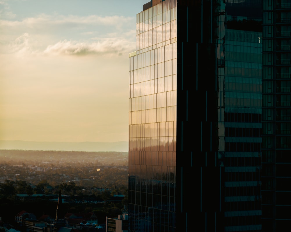 a tall building with a city in the background