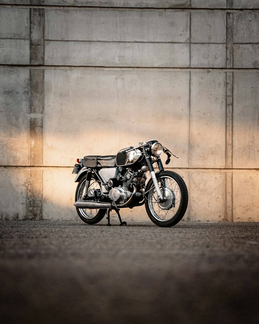 a motorcycle parked against a wall