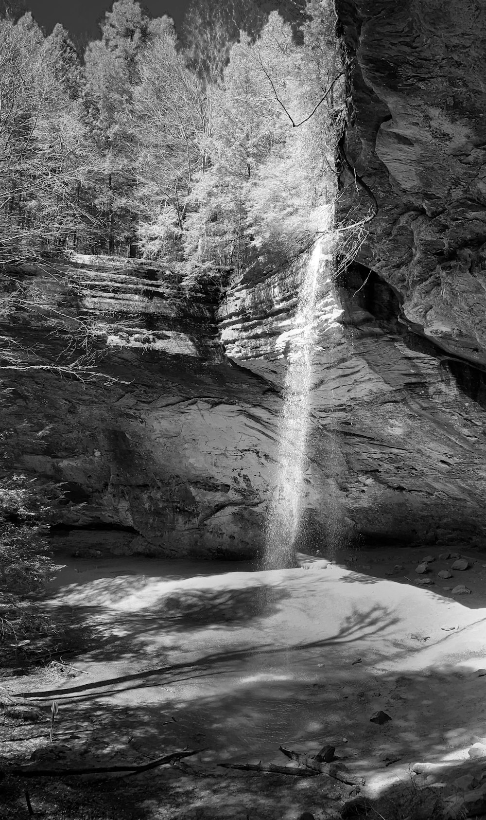 a waterfall over a rocky cliff