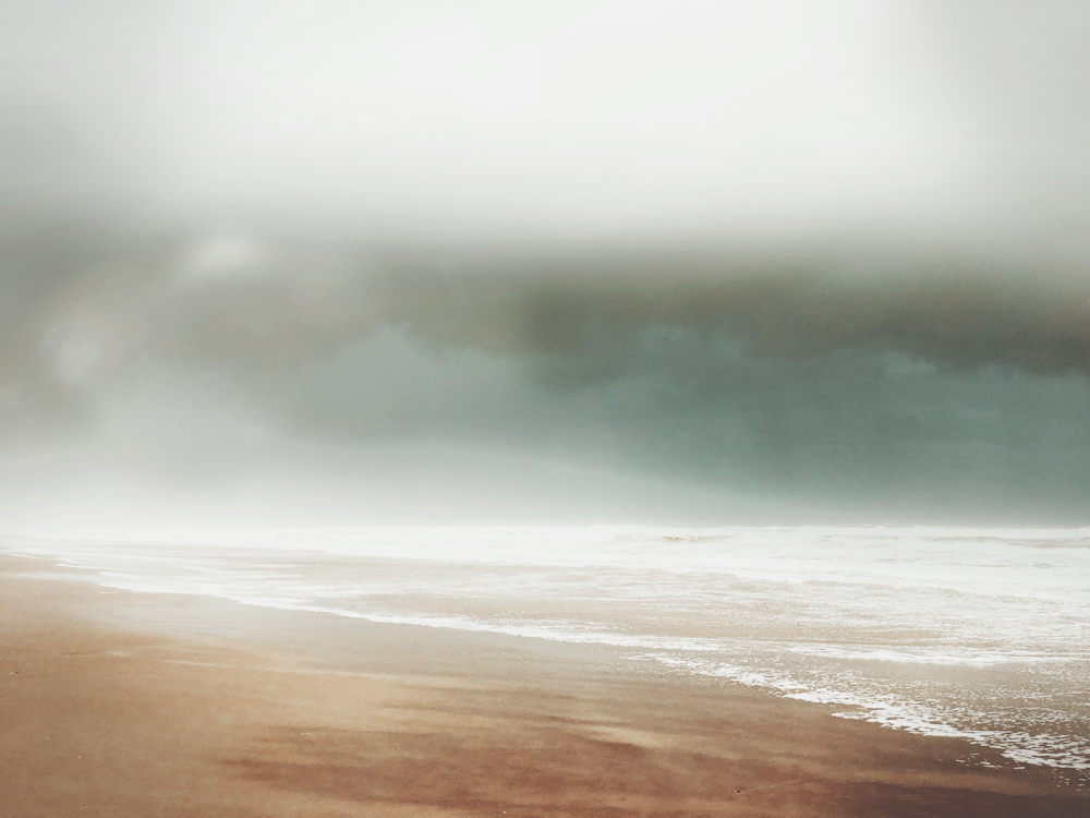 a beach with a cloudy sky