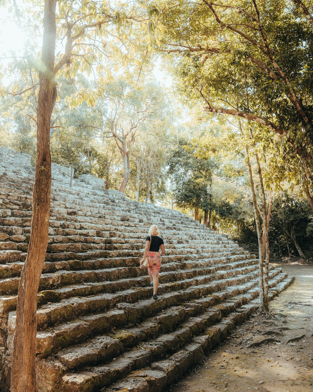 a person walking up a stone staircase