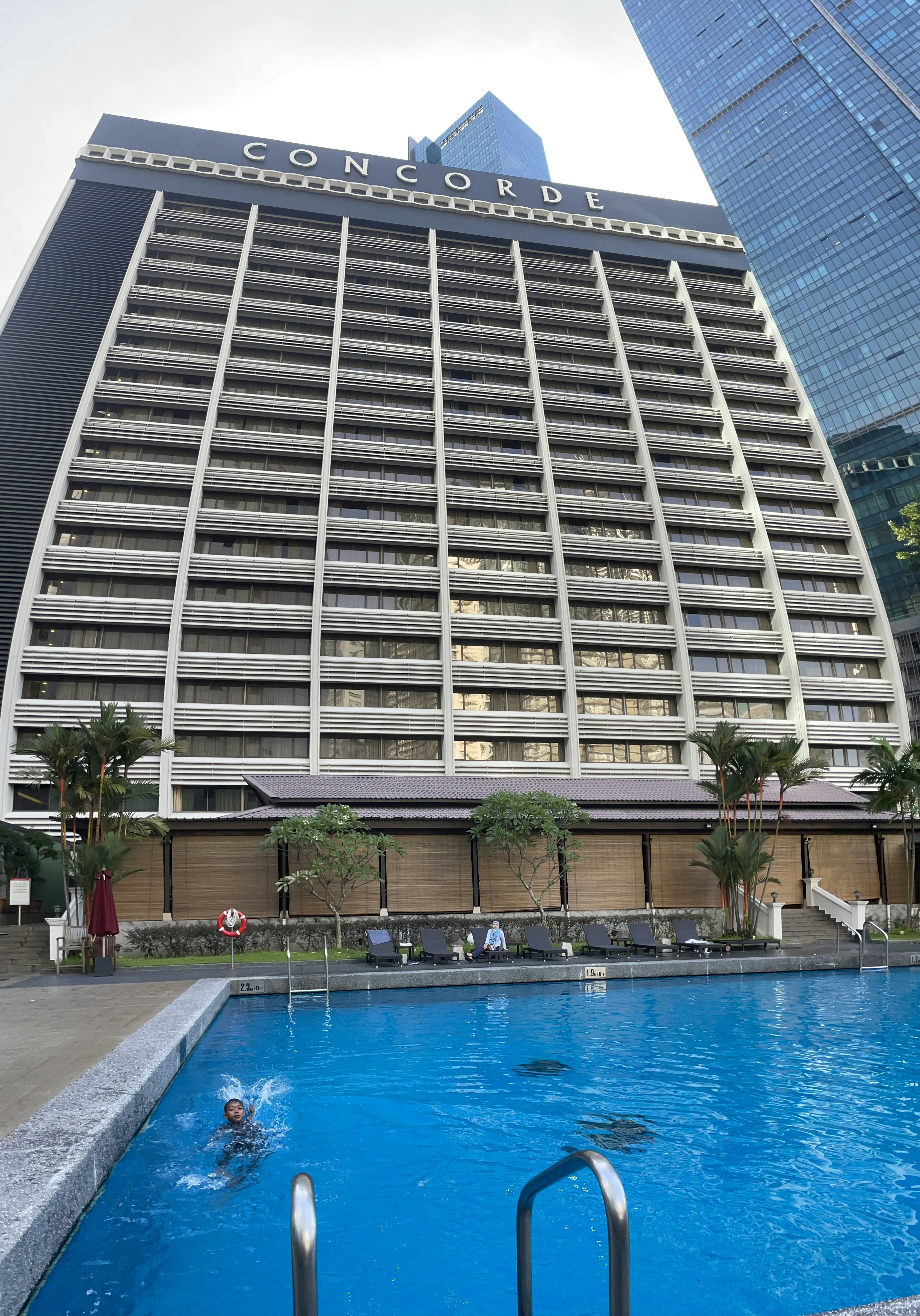 a large building with a pool in front of it
