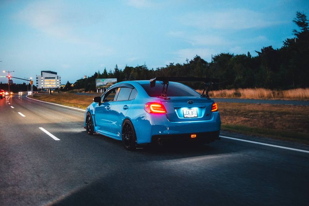 a blue car on a road