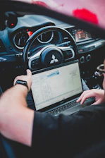 a person holding a laptop