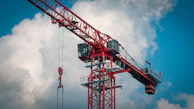 a red crane with a blue sky