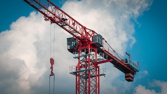 a red crane with a blue sky