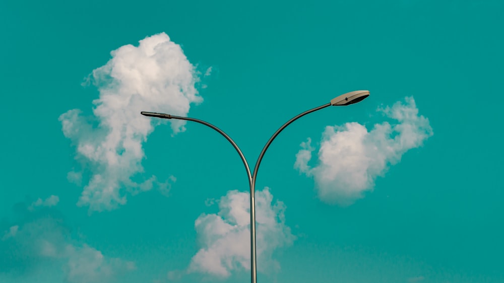 a light post with clouds in the sky