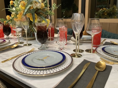 An elegant dining table set with unique tableware and accessories.