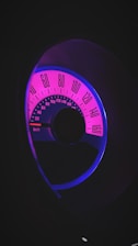 A dynamic speedometer-style dial displaying internet speed in vibrant colors on a dark modern background.