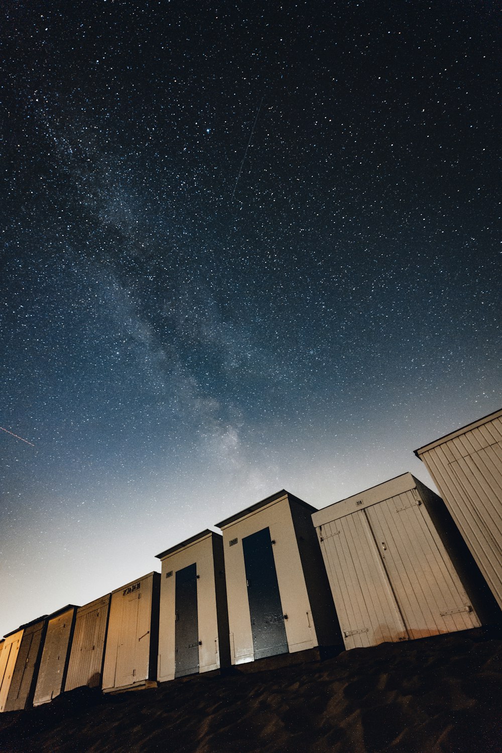 a row of white buildings under a starry sky